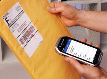 Someone scanning a package with a cell phone