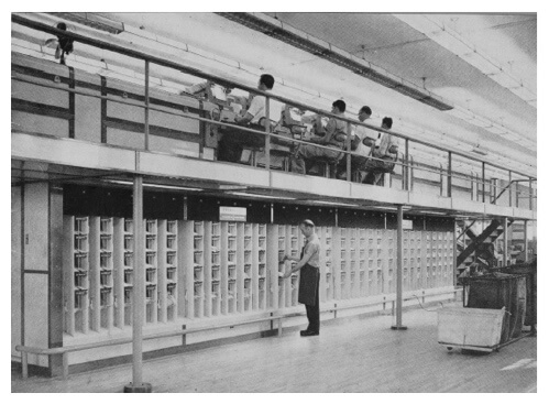Image of employees operating mail sortation machine