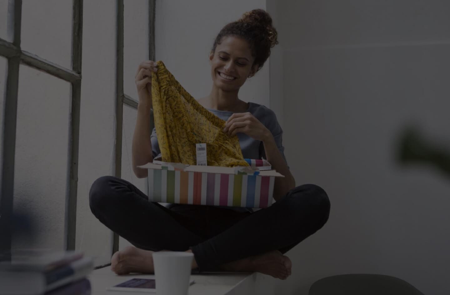 Image of woman opening up package