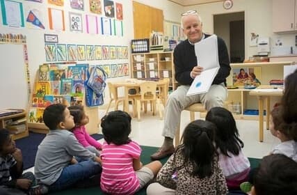 Image of Marc Lautenbach reading to students