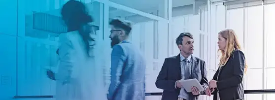 people discussing in office lobby