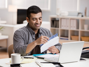 Man looking at an envelope