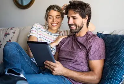 2 persons looking at tablet.