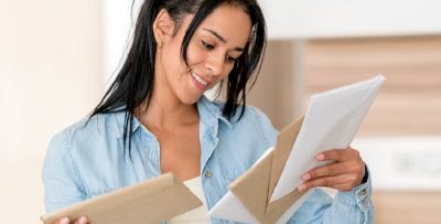 a woman reading a letter 