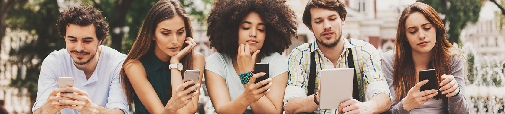 Group of people looking into their mobiles