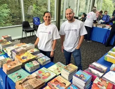 Pitney Bowes volunteers give away books at a local community event