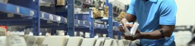 worker sorting mail in warehouse