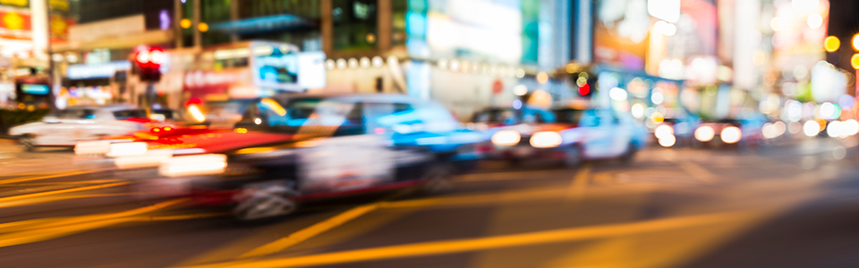 street scene with blurred images of cars