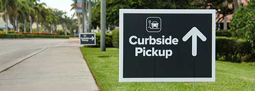 Curbside pickup banner showing on the sidewalk