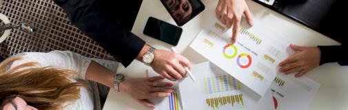 hands of people pointing at reports-analytics hands of people pointing at reports-analytics