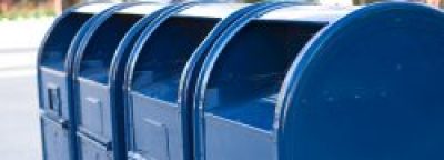 four blue mailboxes in a row