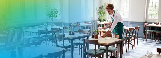 restaurant worker setting a table