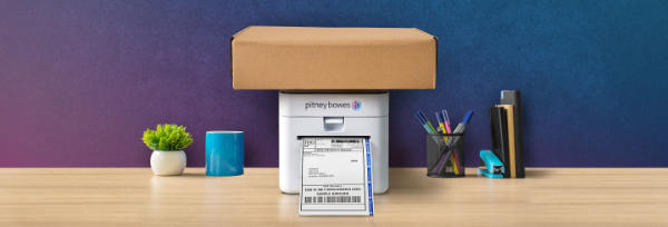 Photo of PitneyShip Cube device on desktop