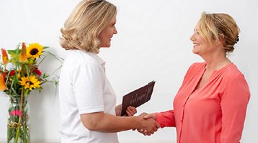 Two women shaking hands