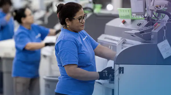 Pitney Bowes employees in working in a Presort facility
