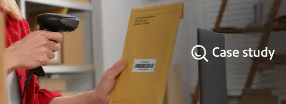 mailroom clerk scanning a barcode on a manila envelope