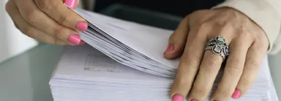 woman reviewing a stack of envelopes