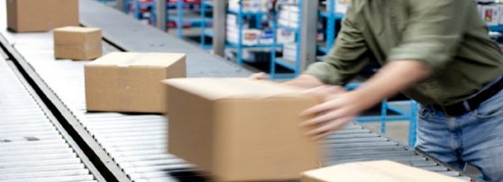 A man handling the shipping boxes