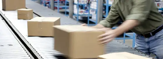 A man handling the shipping boxes