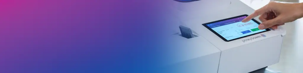 Person using a Pitney Bowes postage meter