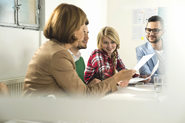 Group of people looking at a paper