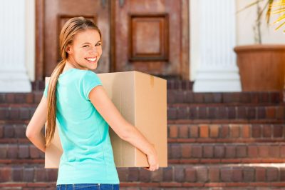 Student carrying shipping box