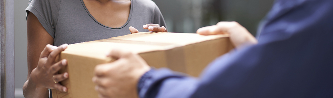 delivery person handing box to customer delivery person handing box to customer
