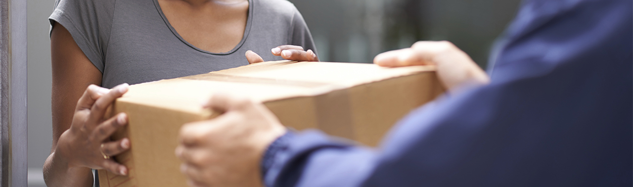 delivery person handing box to customer