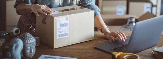 Woman carrying shipping box