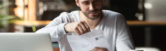 man opening a metered envelope