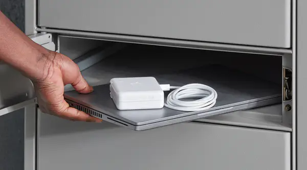person removing a work laptop and powercord from a parcel locker