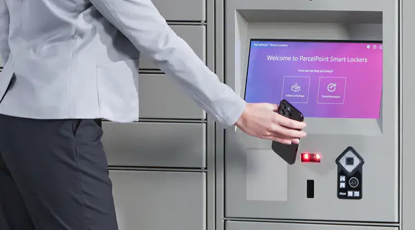person scanning their phone to retreive an item from a parcel locker
