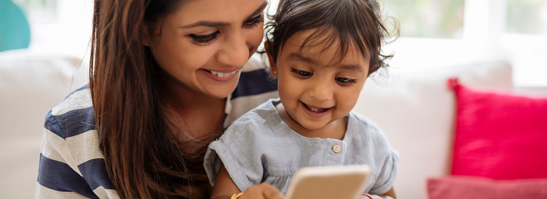 mother and child looking at a mobile phone
