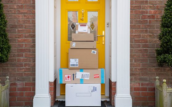 packages stacked in front of a house door
