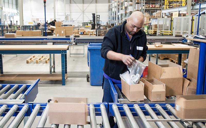 man in a distribution center filling packages